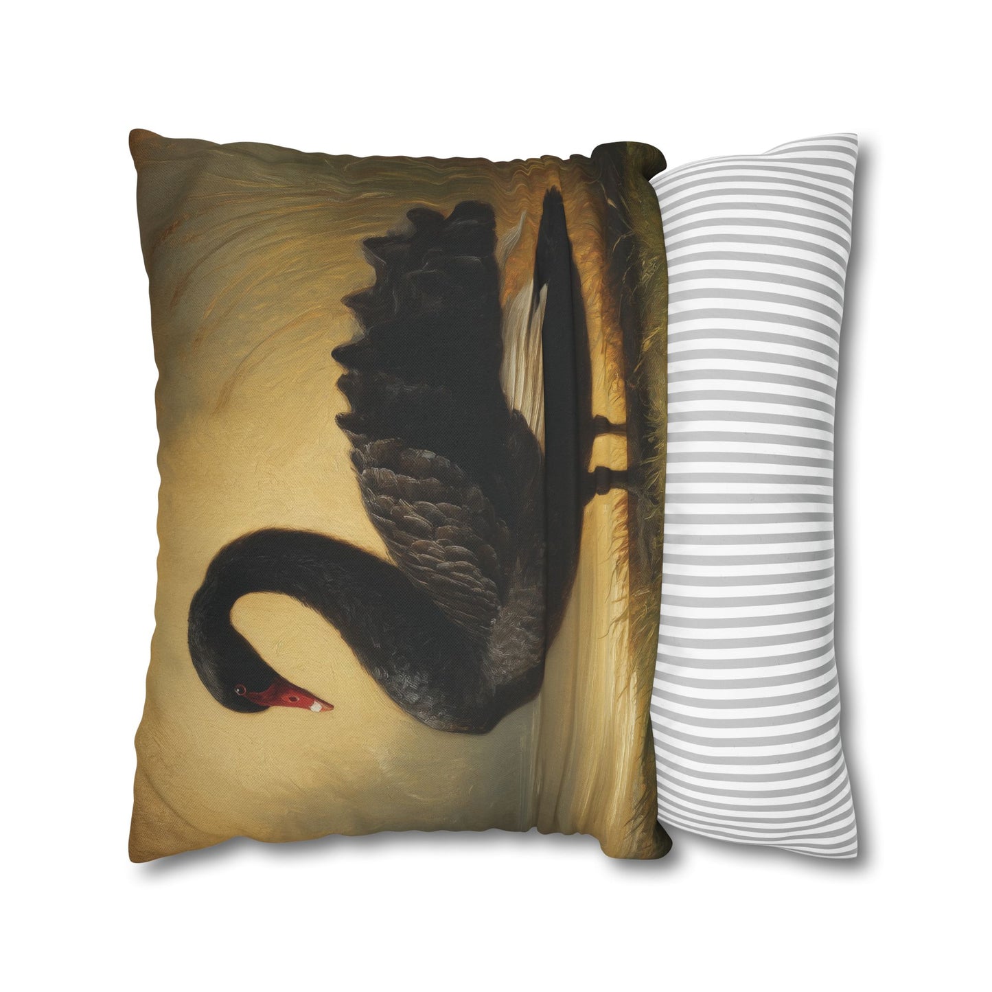 Decorative pillow with a black swan design next to a striped pillow on a white background