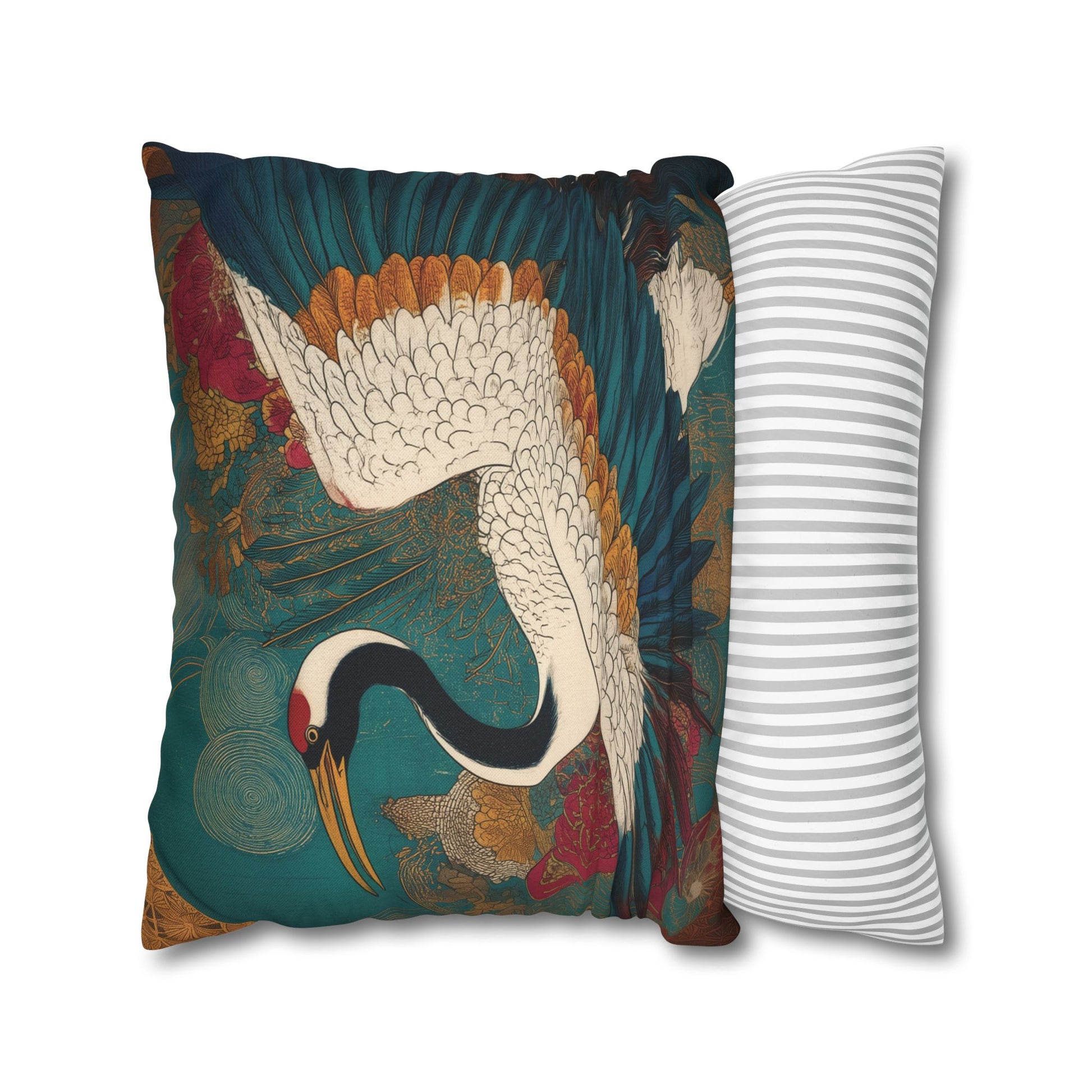 Decorative pillow with crane design next to a striped pillow on a white background