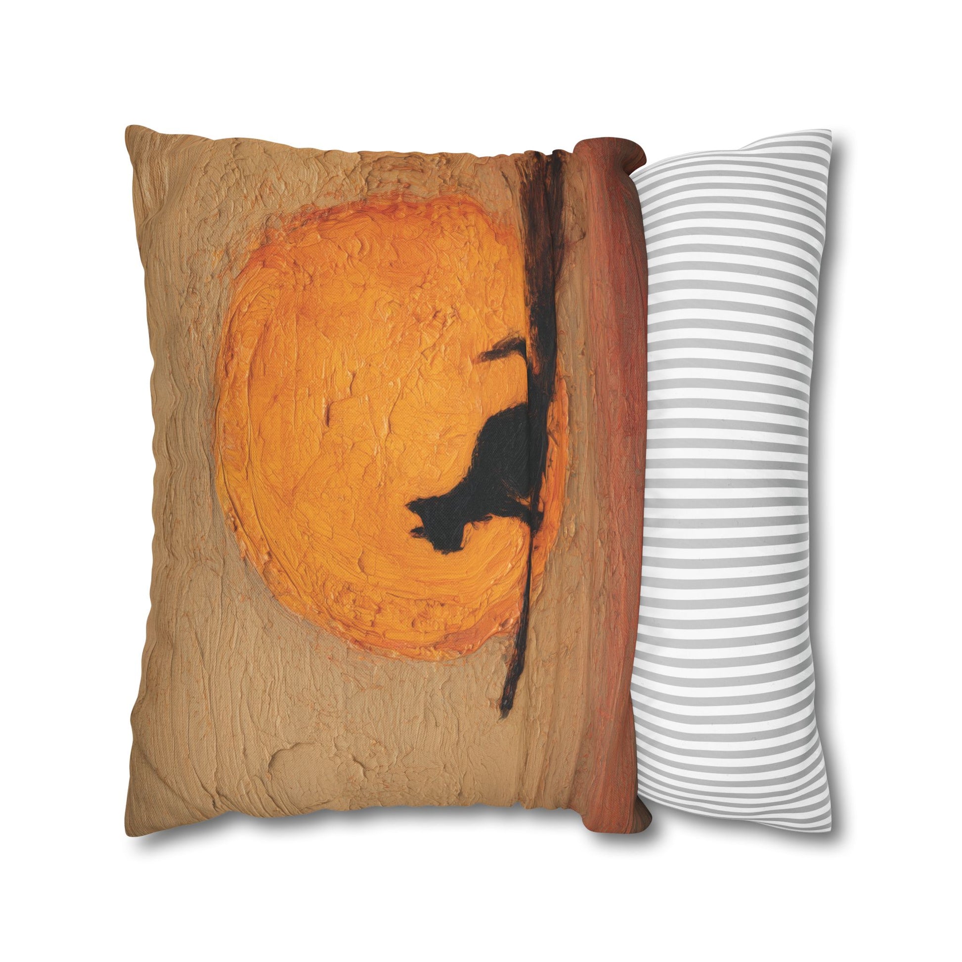 A decorative throw pillow shown on a white background, featuring a printed design of a black cat silhouette against a large orange circular motif on a tan textured background, with a striped side panel in white and gray.