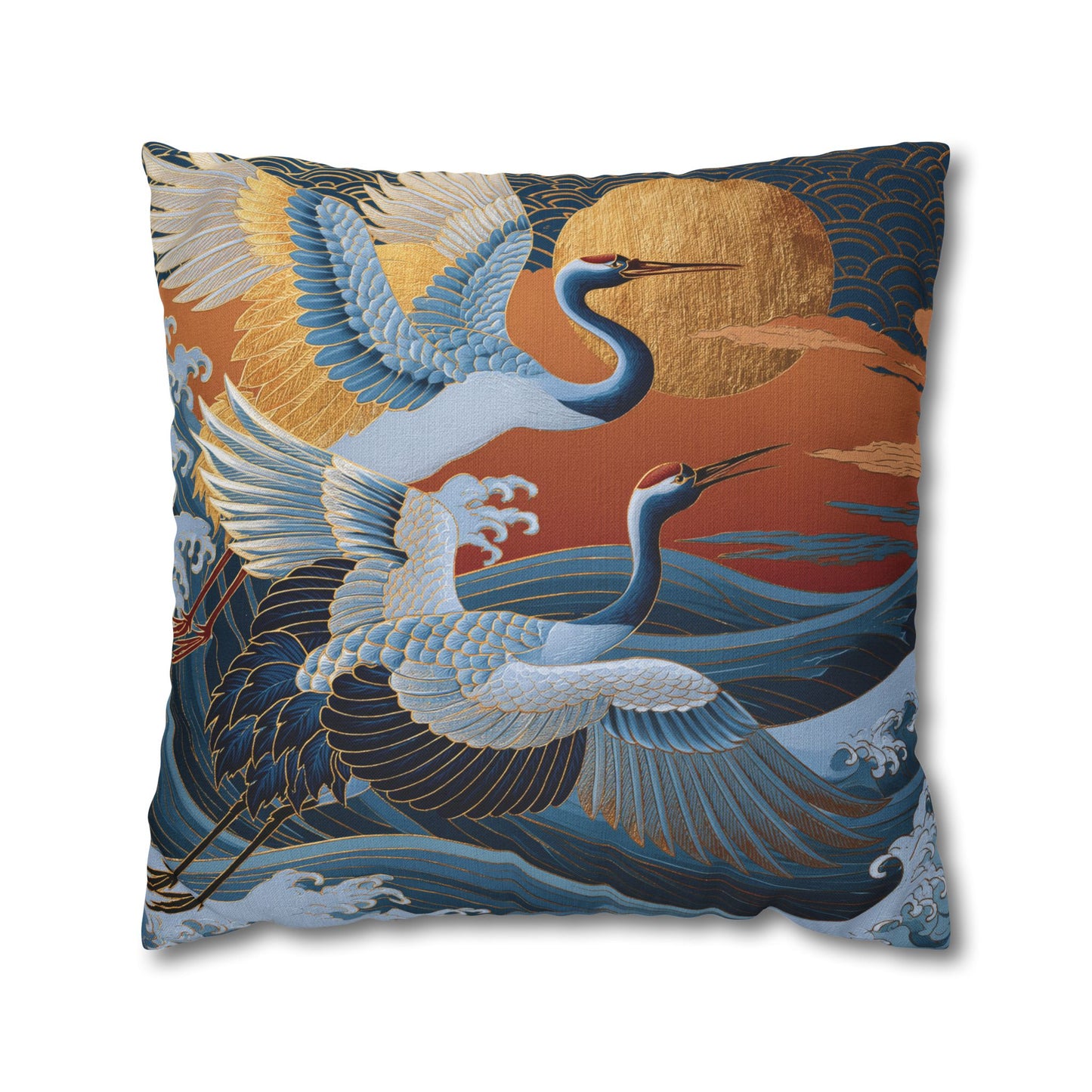 A square decorative throw pillow featuring a Japanese-style print of two blue cranes flying over stylized waves with a large golden sun and orange sky.