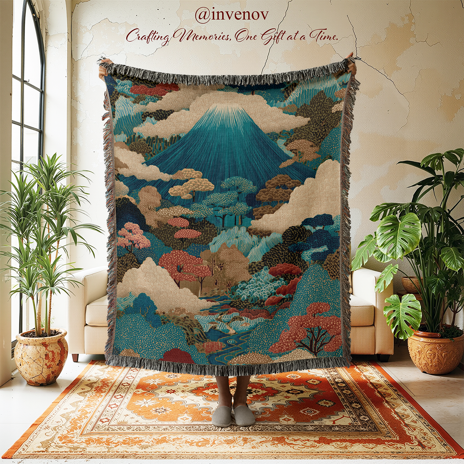 Decorative tapestry with mountain and cloud design in a room with plants and furniture.