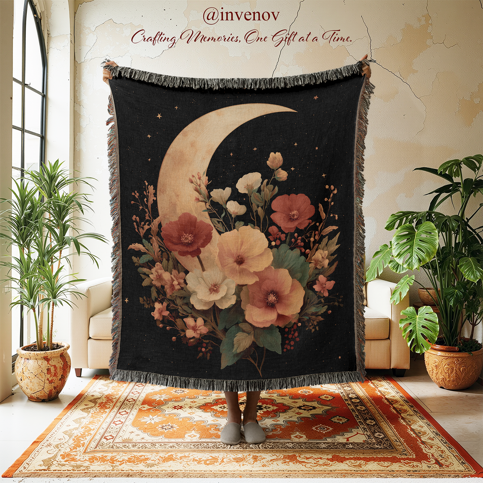 Decorative throw blanket with floral and moon design in a room with plants and furniture.