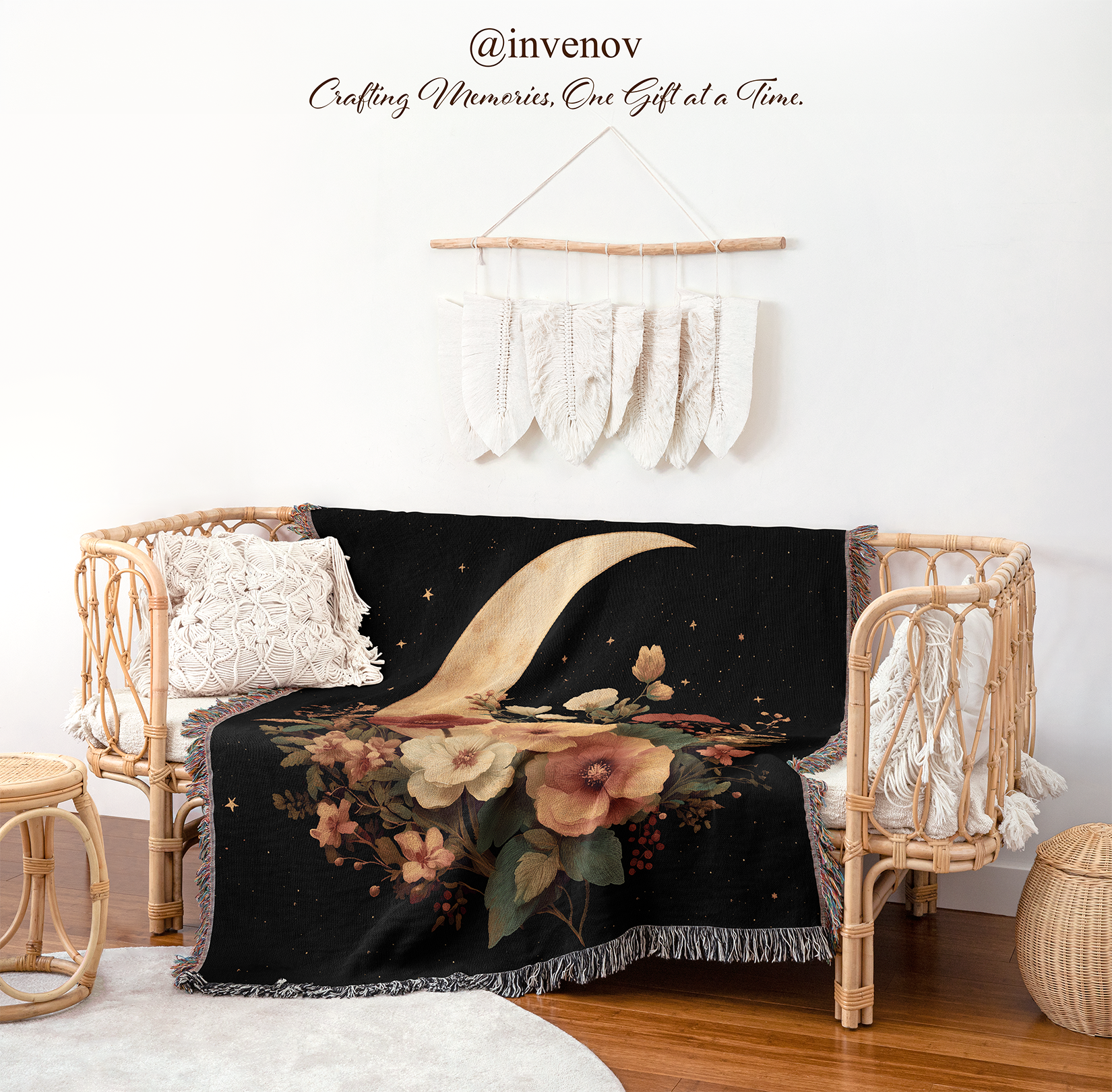 Decorative blanket with floral and moon design draped over a wicker chair