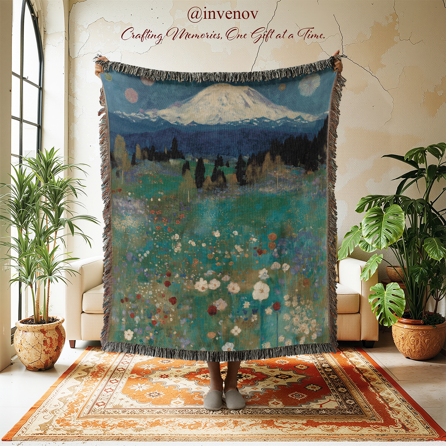 Decorative tapestry with mountain and floral design in a room with plants and furniture.