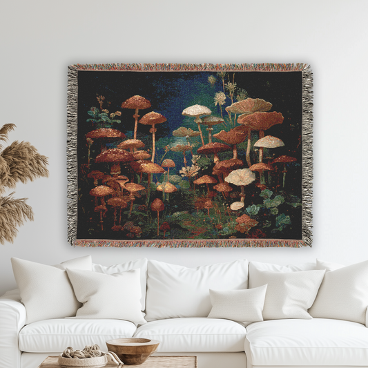 Living room with a white sofa, decorative pillow, and a tapestry of mushrooms on the wall.