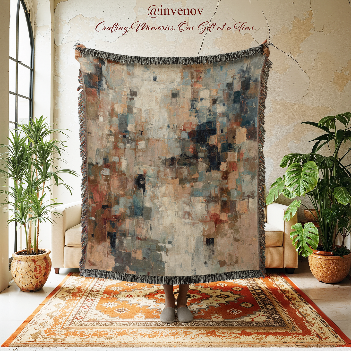 Multicolored woven blanket displayed in a room with plants and furniture.