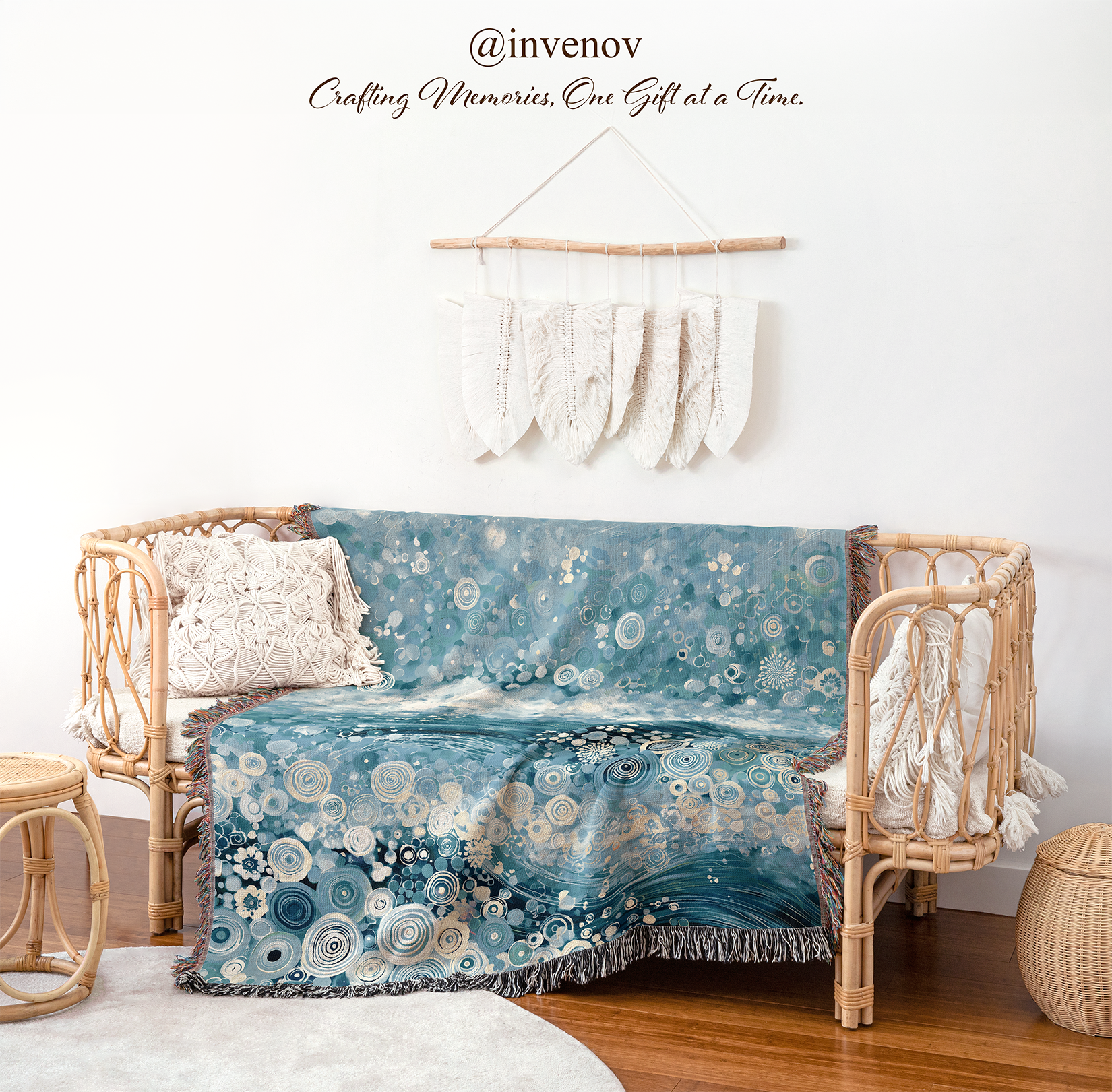 A blue and white bohemian-style throw blanket with a floral and circular pattern draped over a rattan daybed in a styled room setting.