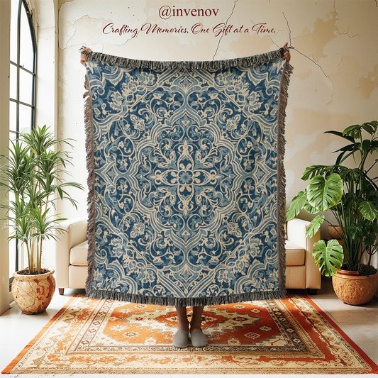 Decorative blue and beige patterned throw blanket displayed in a room with plants and furniture.