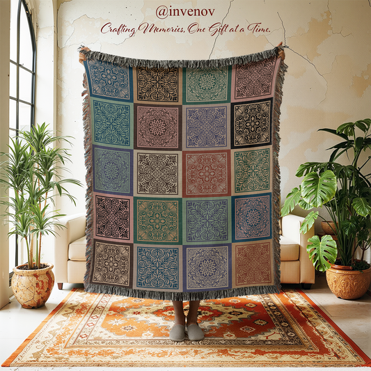 Decorative tapestry with geometric patterns hanging in a room with plants and furniture.