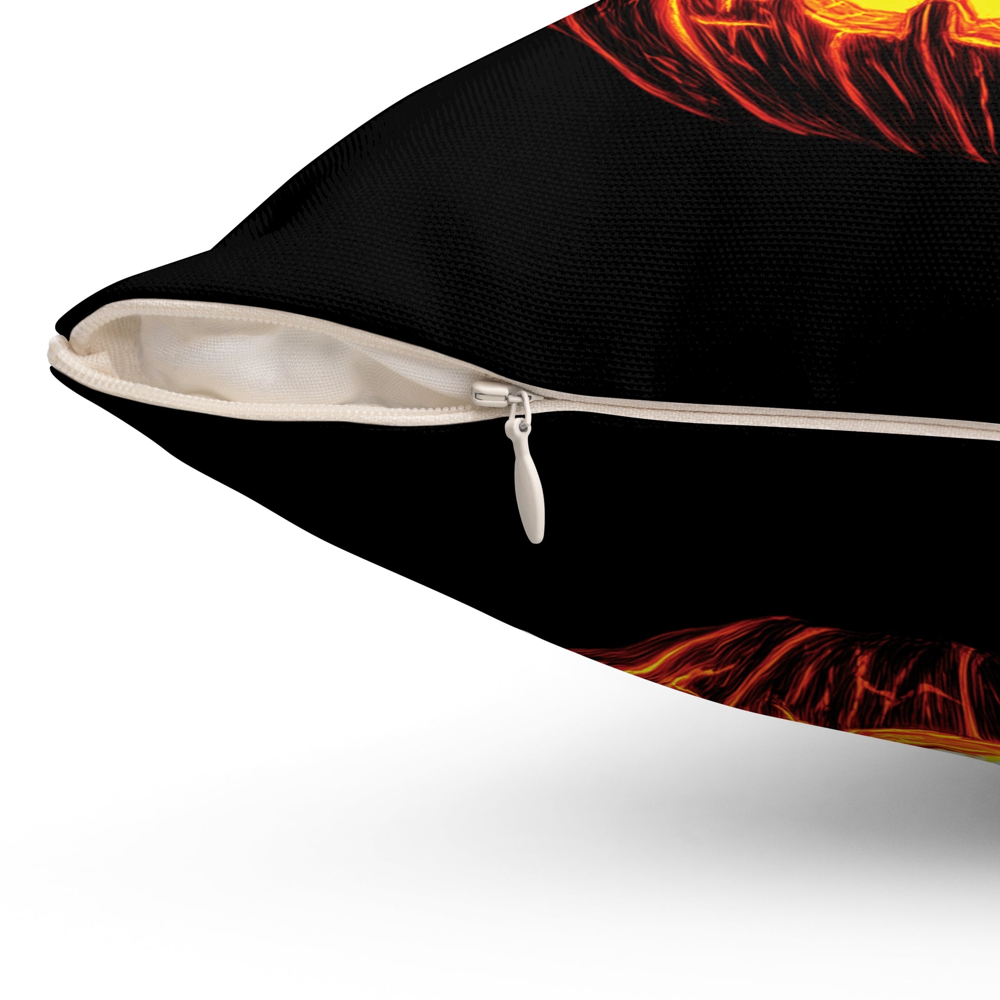 Close-up of a black throw pillow with a white zipper and a fiery red, orange, and yellow flame-like graphic print on a white background.