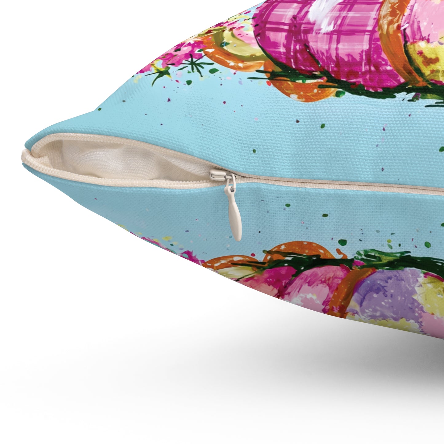 A square decorative throw pillow with a colorful autumn pumpkin design