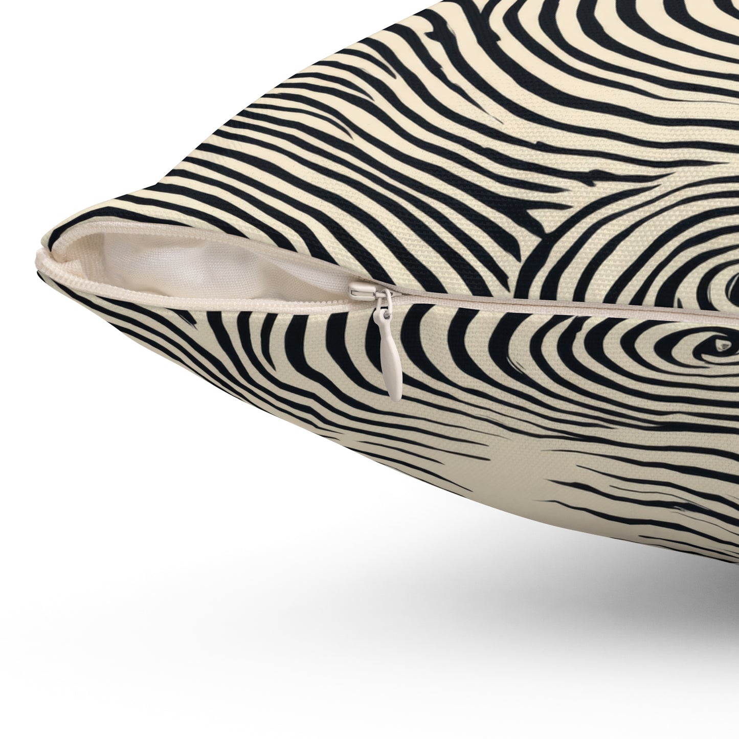 Close-up of a square throw pillow with a blue and cream zebra stripe pattern, showing a zippered side opening.