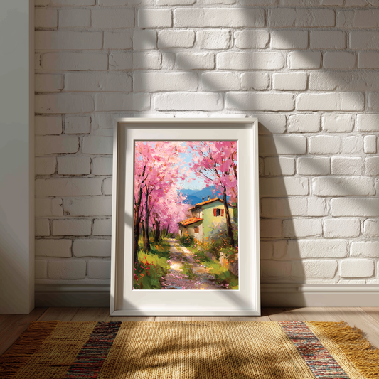 Framed painting of a cherry blossom tree and house against a white brick wall.