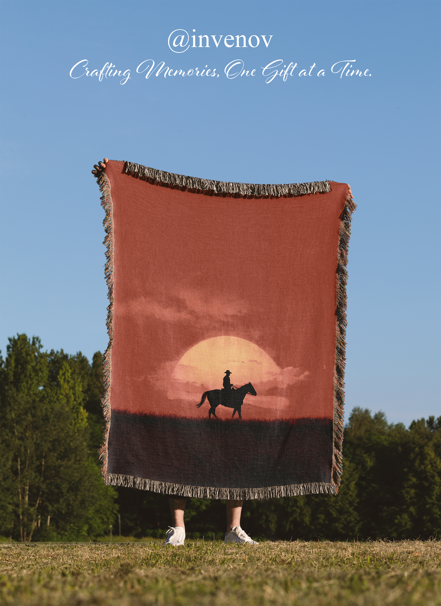 Person holding a blanket with a sunset and horse design