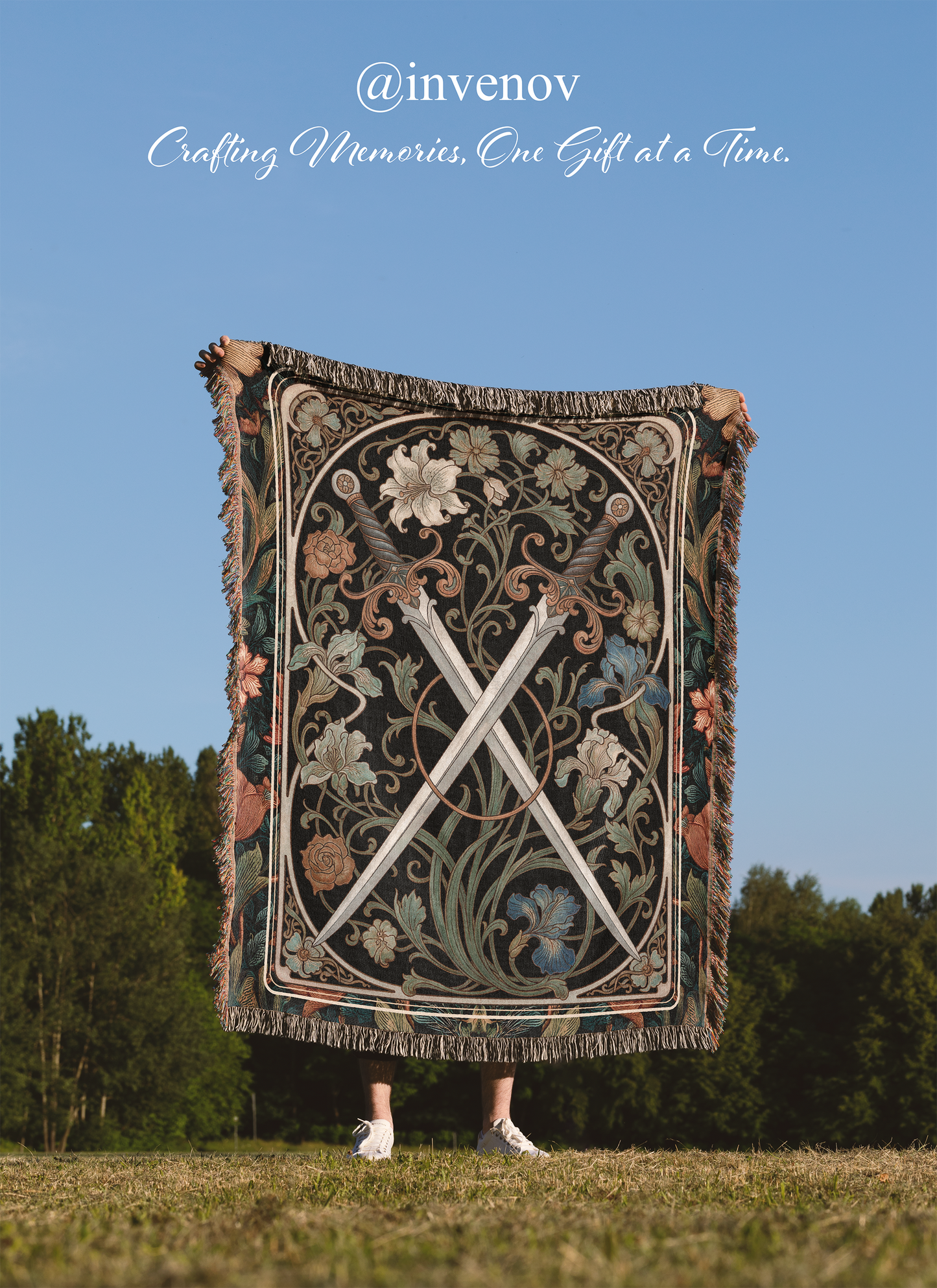 Person holding a decorative blanket with intricate patterns against a blue sky and trees background, featuring the brand 'invenov'.