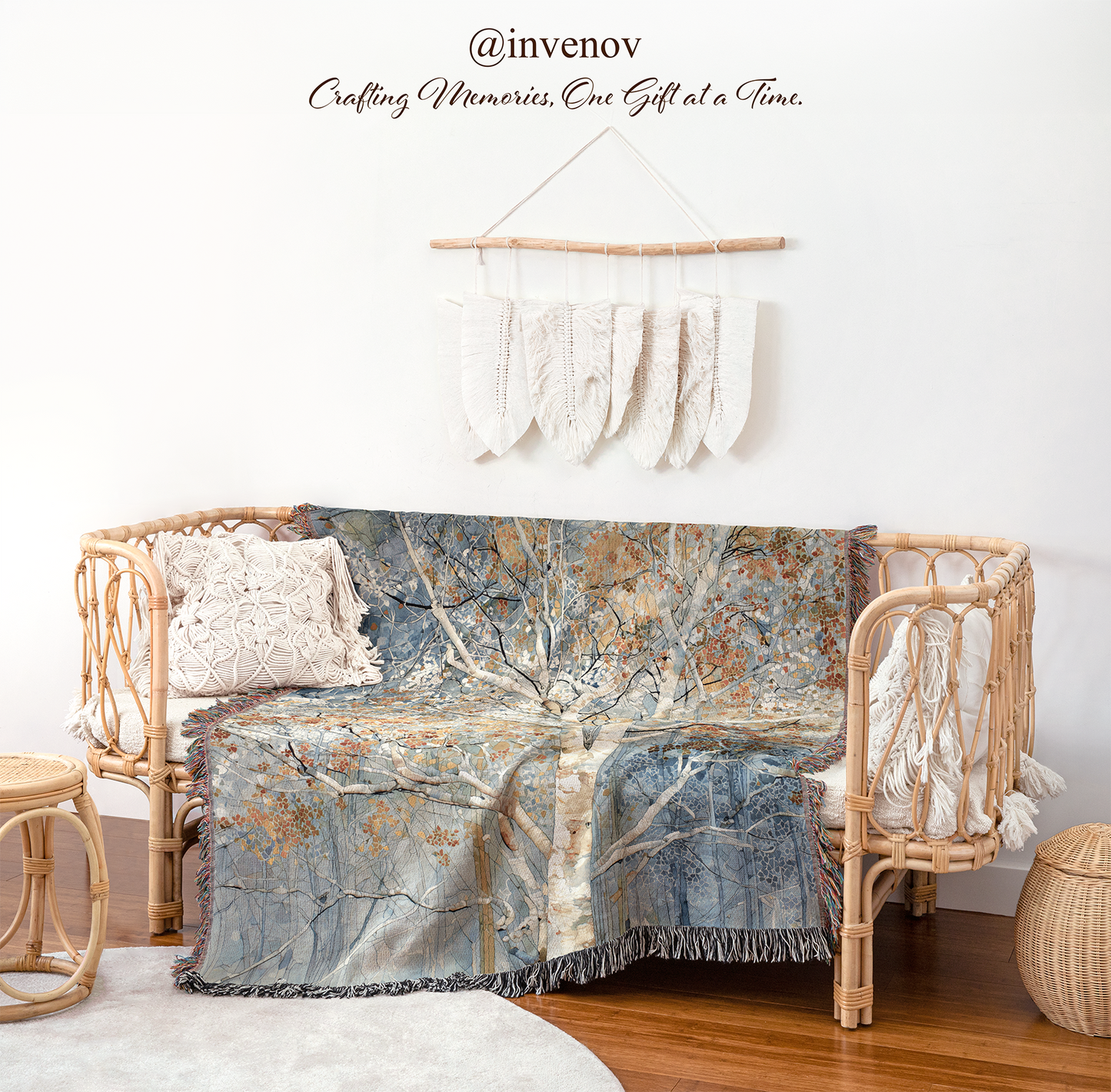 Decorative blanket with tree pattern draped over a wicker chair