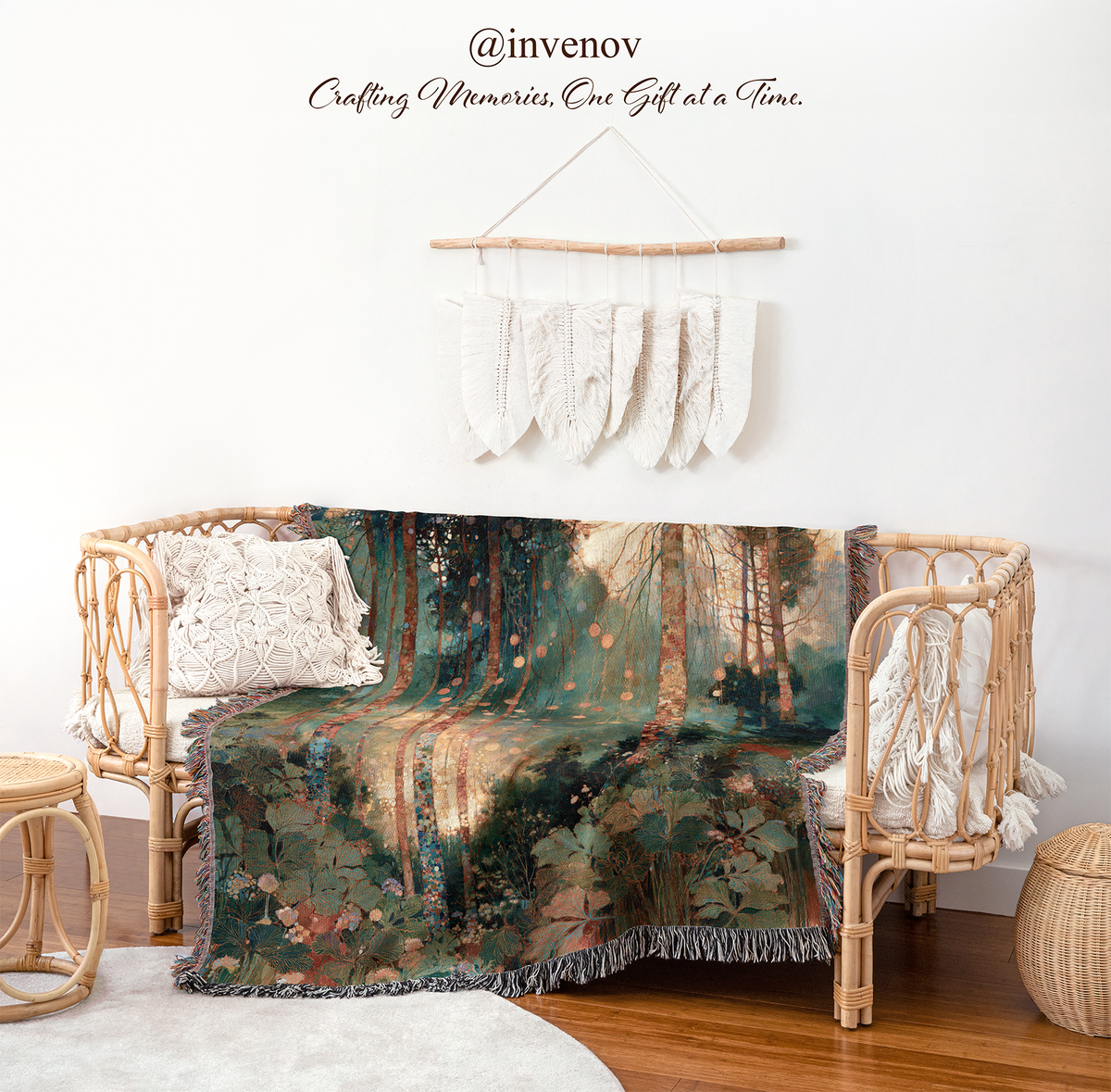 A forest-themed throw blanket draped over a rattan daybed in a styled room setting, with a macrame wall hanging and decorative text on the wall above.