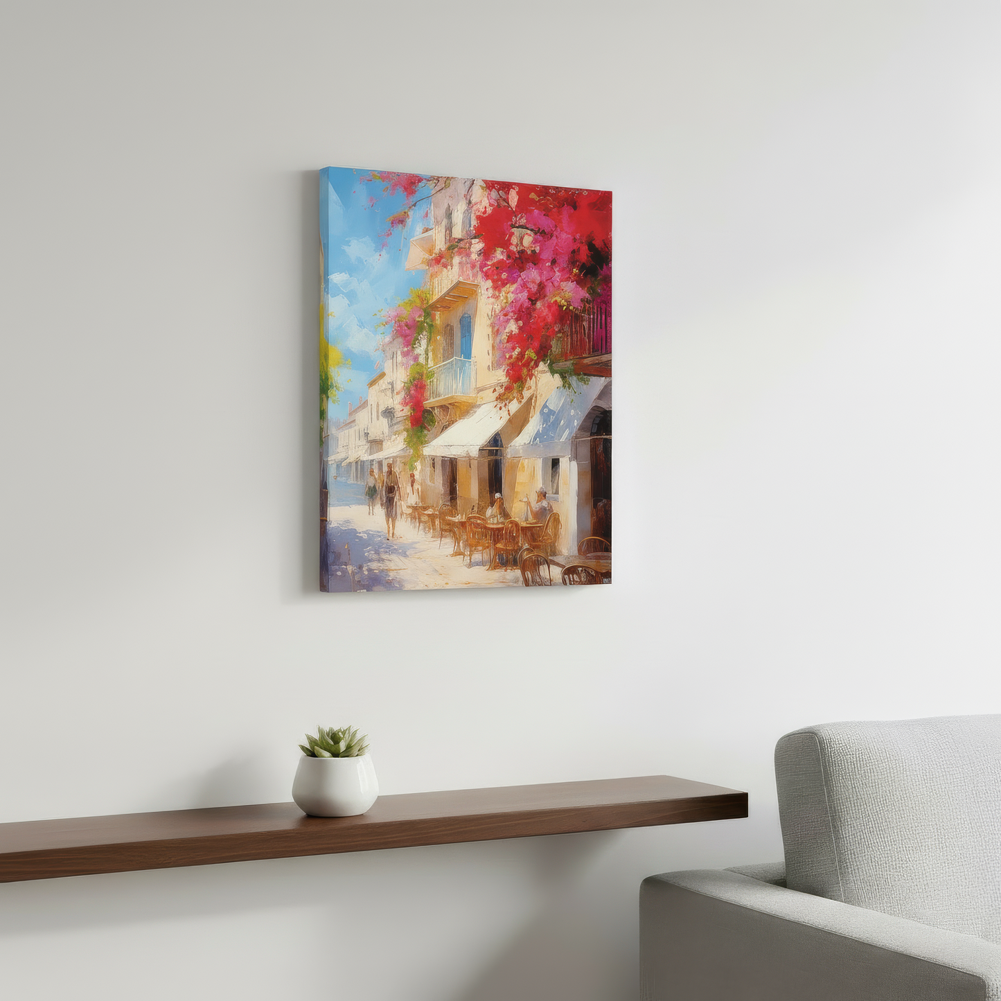 Colorful painting of a street scene on a white wall above a wooden shelf with a plant and a gray sofa.
