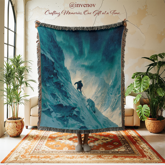 Blanket with mountain and wolf design displayed in a room with plants and furniture.