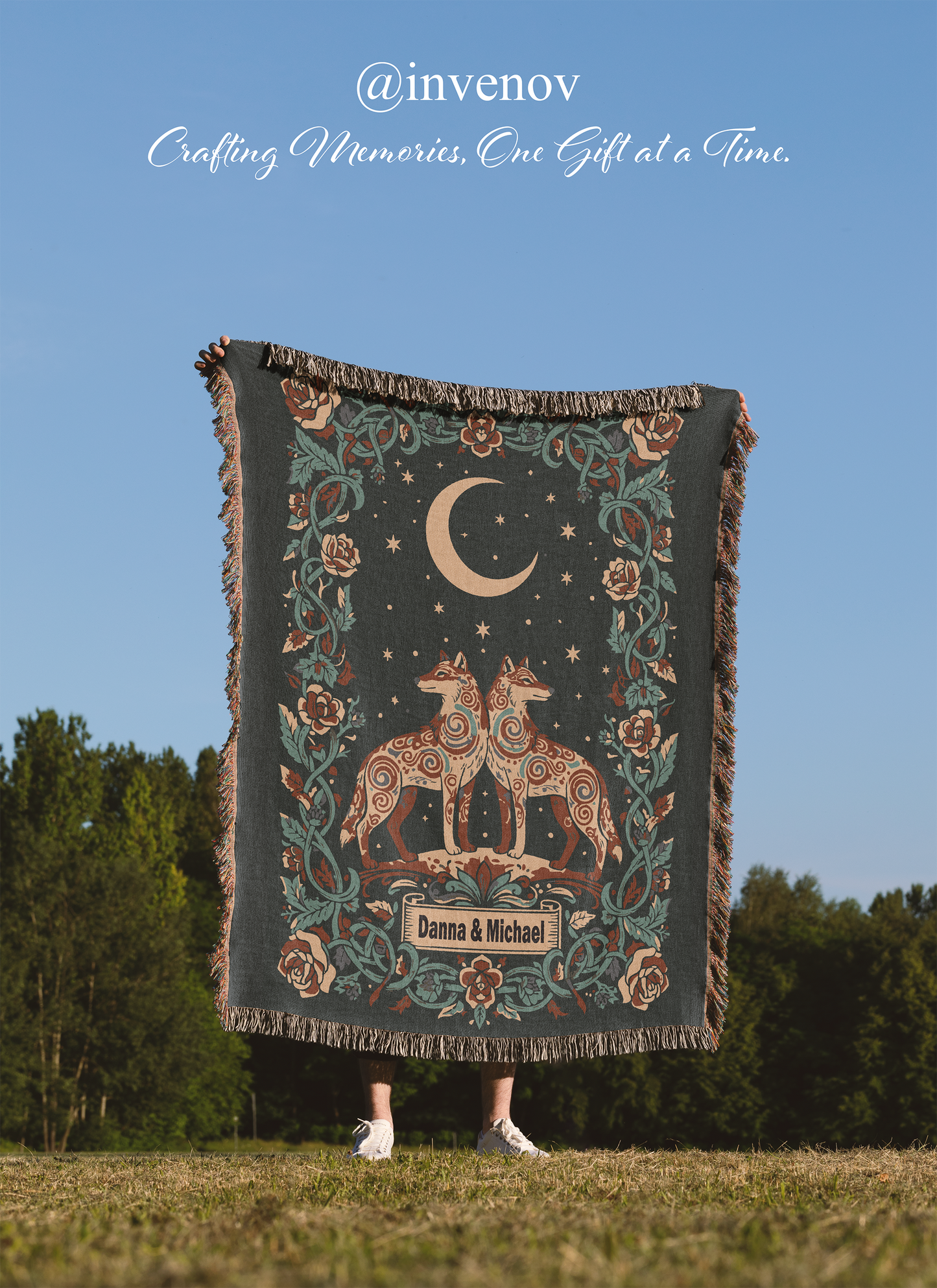 Decorative blanket with celestial design held by a person outdoors