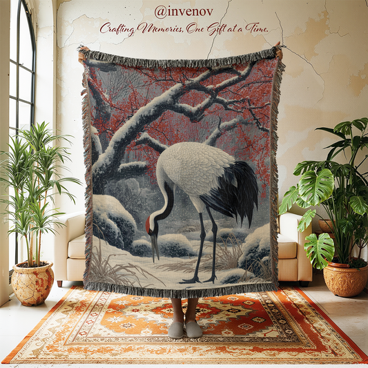 Decorative blanket with a crane design in a room with plants and furniture.